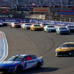 Oct 13, 2024; Concord, North Carolina, USA; NASCAR Cup Series driver Kyle Larson (5) leads the field into turn 4 during the Bank of America ROVAL 400 at Charlotte Motor Speedway Road Course. Mandatory Credit: Peter Casey-Imagn Images