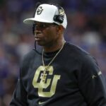 Dec 28, 2024; San Antonio, TX, USA; Colorado Buffaloes head coach Deion Sanders walks on the field during the game against the Brigham Young Cougars at Alamodome.