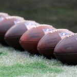Balls are lined up before an NFL football matchup Sunday, Dec. 29, 2024 at EverBank Stadium in Jacksonville, Fla.