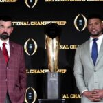 Ohio State Buckeyes head coach Ryan Day (left) and Notre Dame Fighting Irish head coach Marcus Freeman pose with the College Football Playoff National Championship trophy at press conference at The Westin Peachtree Plaza, Savannah Ballroom.