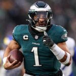 Jan 19, 2025; Philadelphia, Pennsylvania, USA; Philadelphia Eagles quarterback Jalen Hurts (1) runs for a touchdown against the Los Angeles Rams during the first quarter in a 2025 NFC divisional round game at Lincoln Financial Field.