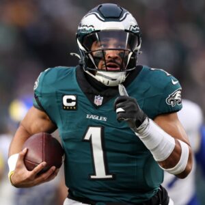 Jan 19, 2025; Philadelphia, Pennsylvania, USA; Philadelphia Eagles quarterback Jalen Hurts (1) runs for a touchdown against the Los Angeles Rams during the first quarter in a 2025 NFC divisional round game at Lincoln Financial Field.