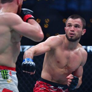 Merab Dvalishvili (red gloves) fights Umar Nurmagomedov (blue gloves) during UFC 311 at Intuit Dome.