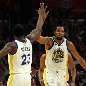 Golden State Warriors forward Kevin Durant (35) celebrates with forward Draymond Green (23) against the LA Clippers in the first half of game six of the first round of the 2019 NBA Playoffs at Staples Center.