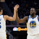 Golden State Warriors guard Jordan Poole (3) and forward Draymond Green (23) celebrate after Poole drew a foul against the Brooklyn Nets during the first half at Chase Center.