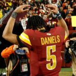 Dec 29, 2024; Landover, Maryland, USA; Washington Commanders quarterback Jayden Daniels (5) celebrates while leaving the field after the Commanders' game against the Atlanta Falcons at Northwest Stadium.