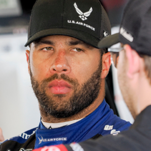 NASCAR Cup Series driver Bubba Wallace (23) talks in his garage Friday, July 19, 2024, during practice for the Brickyard 400 at Indianapolis Motor Speedway.