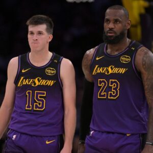 Los Angeles Lakers guard Austin Reaves (15) and forward LeBron James (23) talk on the court during a stoppage in play against the Orlando Magic at Crypto.com Arena.