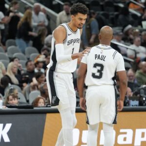 San Antonio Spurs center Victor Wembanyama (1) talks with guard Chris Paul (3) in the first half against the Portland Trail Blazers at Frost Bank Center.