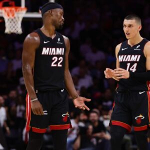 Miami Heat forward Jimmy Butler (22) and guard Tyler Herro (14) talk on the court against the New York Knicks during the second quarter at Kaseya Center.