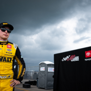 NASCAR Cup Series driver Christopher Bell stands with his crew after exiting his car due to a lightning delay during the Ally 400 at Nashville Superspeedway in Lebanon, Tenn., Sunday, June 30, 2024.