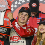 NASCAR Cup Series driver Harrison Burton (21) holds up the trophy after winning the Coke 400 at Daytona International Speedway.