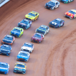 Apr 9, 2023; Bristol, Tennessee, USA; NASCAR Cup Series driver Kyle Larson (5) leads the restart behind the pace truck at the Bristol Motor Speedway Dirt Course. Mandatory Credit: Randy Sartin-Imagn Images