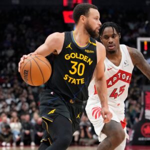 Golden State Warriors guard Stephen Curry (30) dribbles past Toronto Raptors guard Davion Mitchell (45) during the second half at Scotiabank Arena.