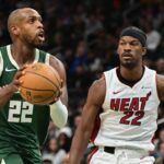 Milwaukee Bucks center Khris Middleton (22) takes a shot against Miami Heat center Jimmy Butler (22) in the second quarter at Fiserv Forum.