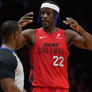 Miami Heat forward Jimmy Butler (22) talks with official Dedric Taylor during a timeout in the second half against the Phoenix Suns at Kaseya Center.