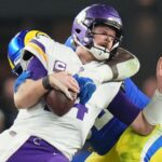 Los Angeles Rams defensive lineman Neville Gallimore (92) sacks Minnesota Vikings quarterback Sam Darnold (14) during their playoff game at State Farm Stadium on Jan. 13, 2025, in Glendale. The Rams beat the Vikings, 27-9.