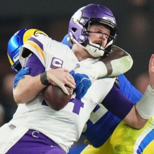 Los Angeles Rams defensive lineman Neville Gallimore (92) sacks Minnesota Vikings quarterback Sam Darnold (14) during their playoff game at State Farm Stadium on Jan. 13, 2025, in Glendale. The Rams beat the Vikings, 27-9.