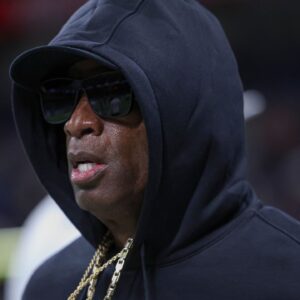 Colorado Buffaloes head coach Deion Sanders jogs on the field before the game against the Brigham Young Cougars at Alamodome.