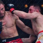 Merab Dvalishvili (red gloves) fights Umar Nurmagomedov (blue gloves) during UFC 311 at Intuit Dome.