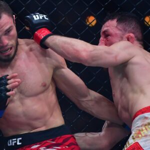 Merab Dvalishvili (red gloves) fights Umar Nurmagomedov (blue gloves) during UFC 311 at Intuit Dome.