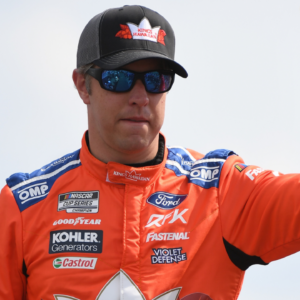 Jun 26, 2022; Nashville, Tennessee, USA; NASCAR Cup Series driver Brad Keselowski (6) waives to fans as he walks the stage during driver introductions before the Ally 400 at Nashville Superspeedway. Mandatory Credit: Christopher Hanewinckel-Imagn Images