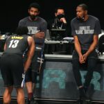 Brooklyn Nets point guard Kyrie Irving (C) and power forward Kevin Durant (R) talk to shooting guard James Harden (13) before checking into the game during the fourth quarter against the Los Angeles Clippers at Barclays Center.