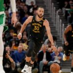 Golden State Warriors guard Stephen Curry (30) dribbles the ball up the court against the Boston Celtics in the third quarter at the Chase Center.