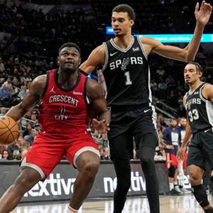 New Orleans Pelicans forward Zion Williamson (1) drives to the basket while defended by San Antonio Spurs forward Victor Wembanyama (1) during the first half at Frost Bank Center