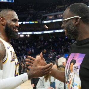 Los Angeles Lakers forward LeBron James (left) talks with Golden State Warriors forward Draymond Green (right) after the game at Chase Center.