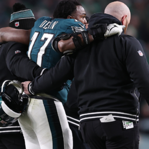 Philadelphia Eagles linebacker Nakobe Dean (17) is helped off the field against the Green Bay Packers during the first half in an NFC wild card game at Lincoln Financial Field.