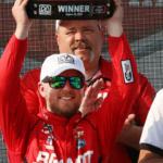 Justin Allgaier raises the trophy he won high at the Johnsonville 180, Saturday, August 25, 2018 at Elkhart Lake's Road America. 082518 She Johnsonville 180 Gk 01