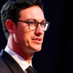 NASCAR Cup Series driver Joey Logano (22) talks to the audience after being announced as the three time Cup champion during the NASCAR Awards Banquet at Charlotte Convention Center.