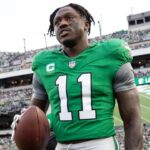Dec 29, 2024; Philadelphia, Pennsylvania, USA; Philadelphia Eagles wide receiver A.J. Brown (11) carries his touchdown ball back to quarterback Tanner McKee (not pictured) during the third quarter against the Dallas Cowboys at Lincoln Financial Field.