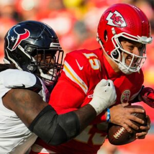 Dec 21, 2024; Kansas City, Missouri, USA; Kansas City Chiefs quarterback Patrick Mahomes (15) is tackled by Houston Texans defensive tackle Mario Edwards Jr. (97) during the first half at GEHA Field at Arrowhead Stadium.