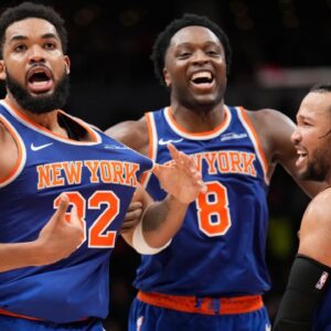 New York Knicks guard Jalen Brunson (11) and forward OG Anunoby (8) react after a three point basket by center Karl-Anthony Towns (32) to clinch a win over the Toronto Raptors during the second half at Scotiabank Arena.