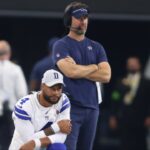 Dallas Cowboys quarterback Dak Prescott (4) and offensive coordinator Brian Schottenheimer watch a play in the game against the Jacksonville Jaguars at AT&T Stadium.