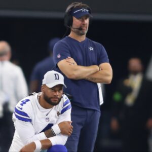 Dallas Cowboys quarterback Dak Prescott (4) and offensive coordinator Brian Schottenheimer watch a play in the game against the Jacksonville Jaguars at AT&T Stadium.