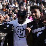 Colorado Buffaloes safety Shilo Sanders (21) and head coach Deion Sanders and quarterback Shedeur Sanders (2) and social media producer Deion Sanders Jr. following the win against the Oklahoma State Cowboys at Folsom Field.
