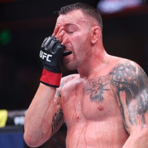 Colby Covington (red gloves) fights Joaquin Buckley (blue gloves) at Amalie Arena.