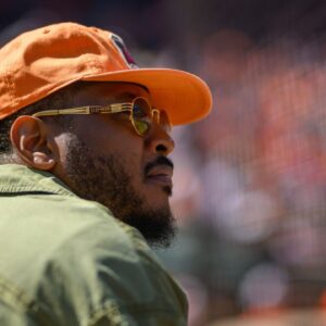 Former professional basketball player Carmelo Anthony attends a game between the Baltimore Orioles and the Tampa Bay Rays at Oriole Park at Camden Yards.