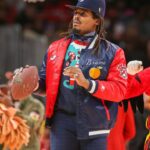 Former NFL quarterback Cam Newton on the court during a game between the Atlanta Hawks and Detroit Pistons in the second quarter at State Farm Arena.