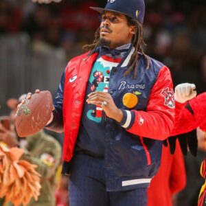Former NFL quarterback Cam Newton on the court during a game between the Atlanta Hawks and Detroit Pistons in the second quarter at State Farm Arena.