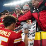 Kansas City Chiefs quarterback Patrick Mahomes (15) signs autographs for fans after the win over the Las Vegas Raiders at GEHA Field at Arrowhead Stadium.
