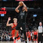 Brooklyn Nets forward Cam Johnson (2) shoots the ball over Toronto Raptors guard Gradey Dick (1) in the first half at Scotiabank Arena