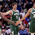 Milwaukee Bucks forward Giannis Antetokounmpo (34) slaps hands with forward Khris Middleton (22) and center Brook Lopez (11) after a play against the New Orleans Pelicans during the second half at Smoothie King Center.