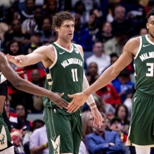 Milwaukee Bucks forward Giannis Antetokounmpo (34) slaps hands with forward Khris Middleton (22) and center Brook Lopez (11) after a play against the New Orleans Pelicans during the second half at Smoothie King Center.