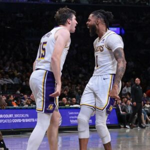 Los Angeles Lakers guard Austin Reaves (15) and guard D'Angelo Russell (1) react after a basket during the second half against the Brooklyn Nets at Barclays Center.