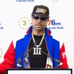 Philadelphia 76ers great Allen Iverson speaks at the podium during the unveiling of a statue honoring him in a ceremony at Penn Medicine Philadelphia 76ers Training Complex.