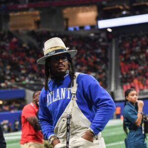 Former Auburn and NFL star Cam Newton stands on the sidelines during the Cricket Celebration Bowl game between Florida A&M University and Howard University at Mercedes-Benz Stadium in Atlanta